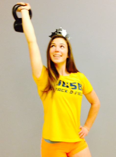 Model Katie Lee holds a kettle bell pondering her New years Resolution.